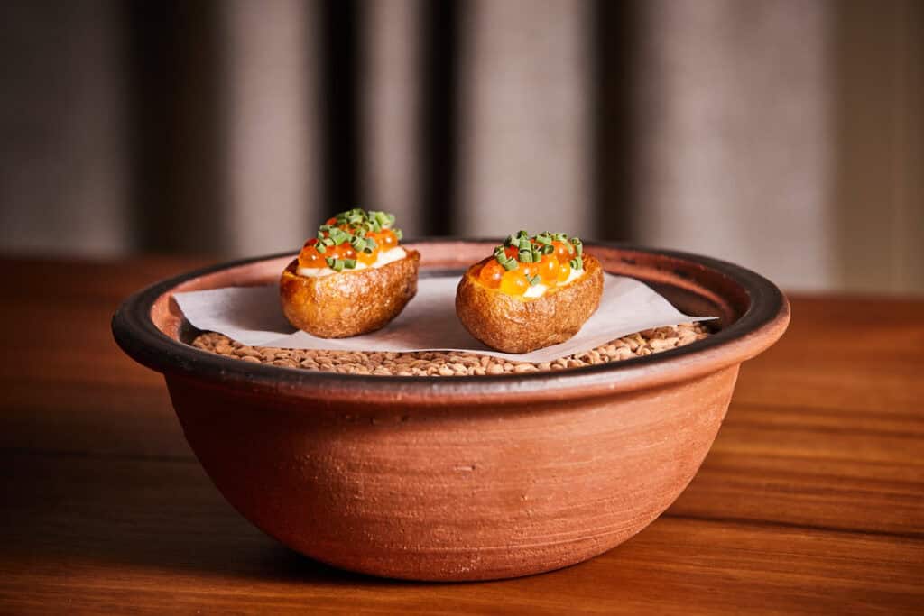 Two gourmet deviled potatoes served in a rustic bowl for a stylish presentation.