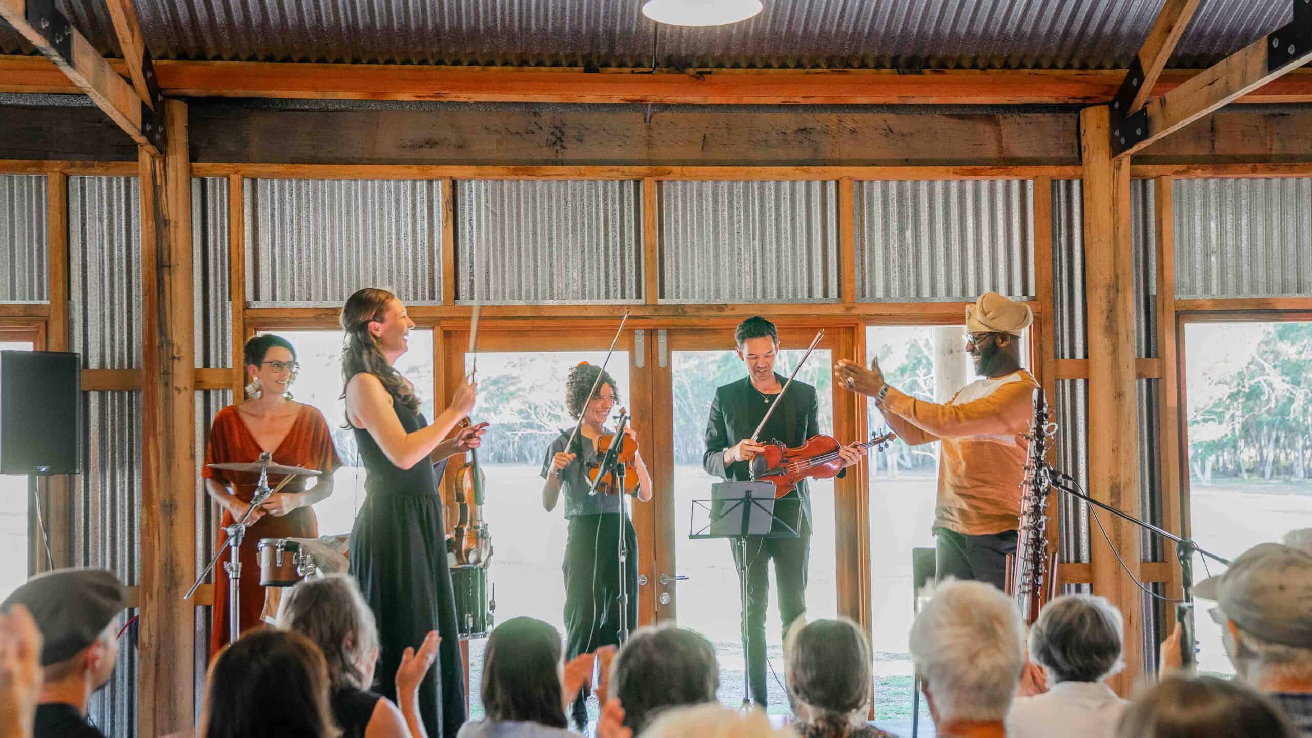 Live band performing at Megalong Valley Music Festival 2027 in a rustic venue.
