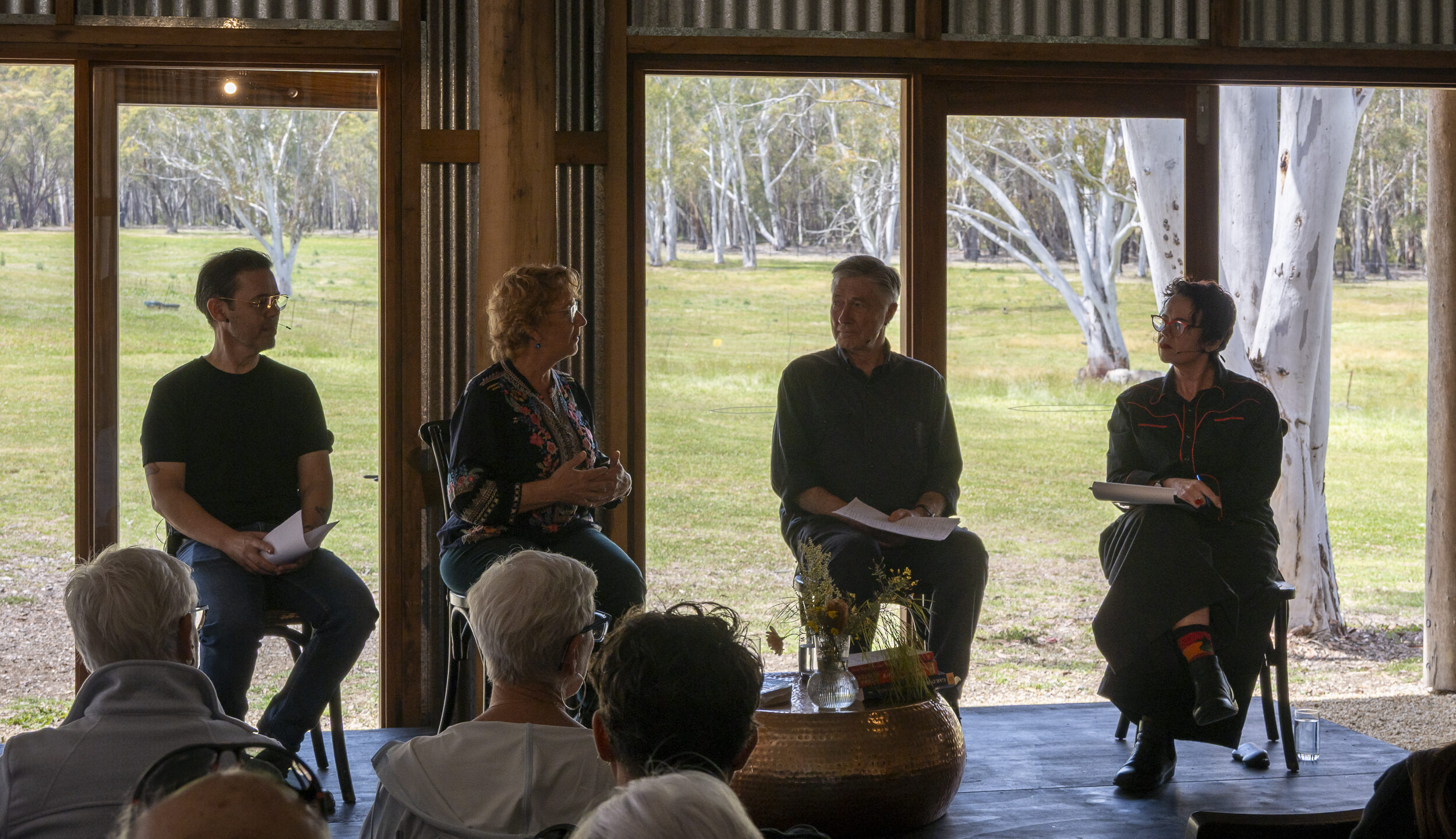 A Blue Mountains Writers' Festival panel on stage at The Old Stables, with the valley through the open doors