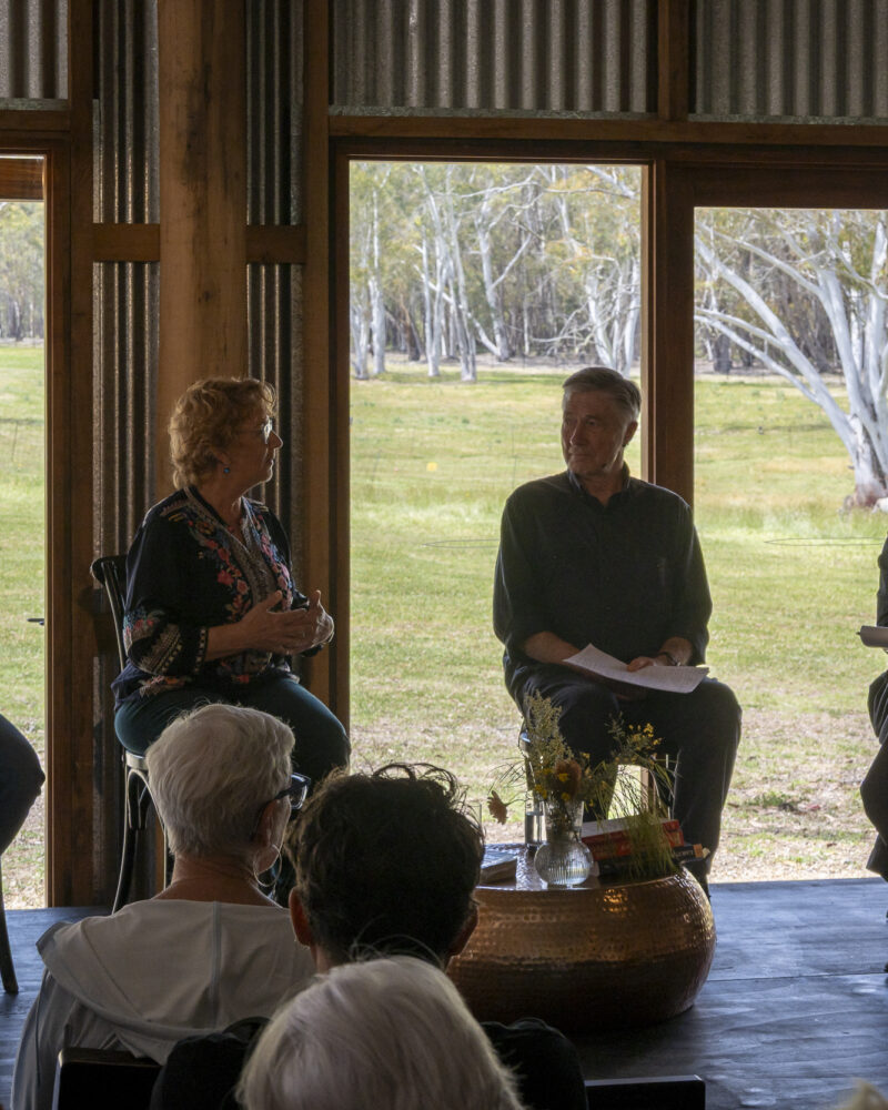 A Blue Mountains Writers' Festival panel on stage at The Old Stables, with the valley through the open doors