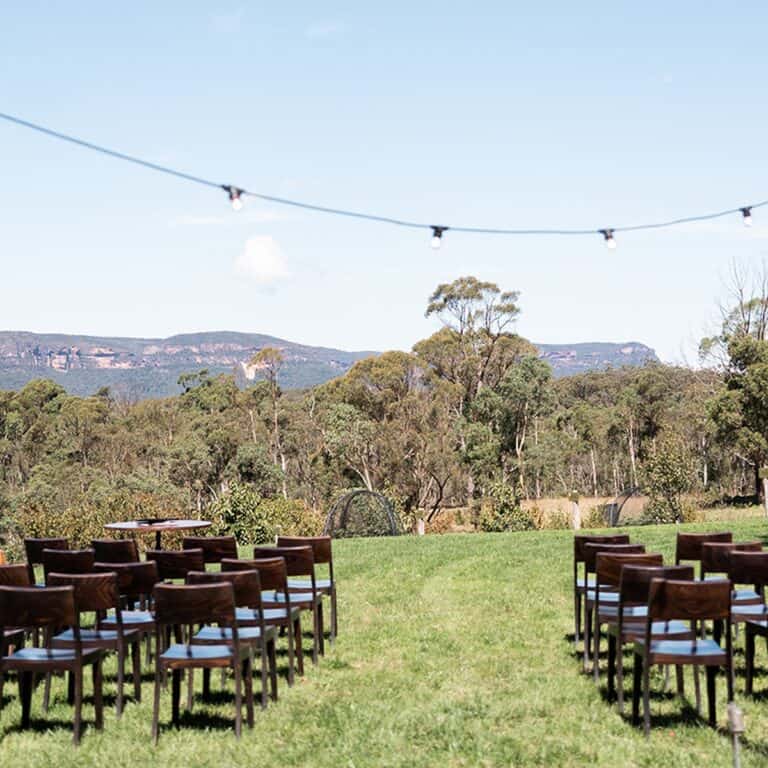 Chairs arranged outdoors for a venue hire event with scenic mountain view.