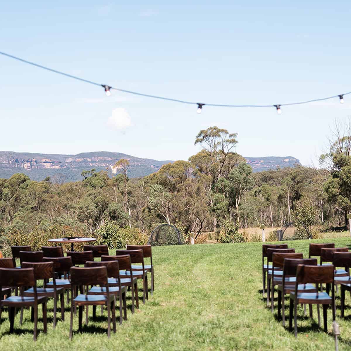 Chairs arranged outdoors for a venue hire event with scenic mountain view.