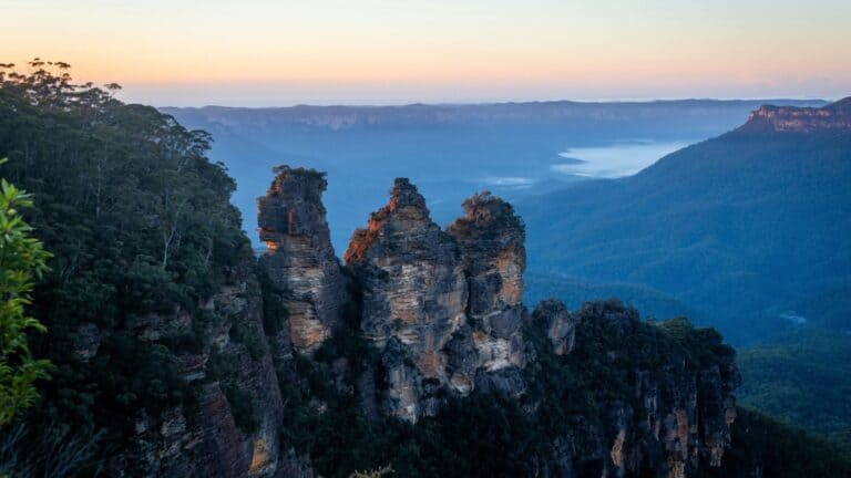 Scenic view of the Three Sisters rock formation at sunrise in Blue Mountains, Australia.