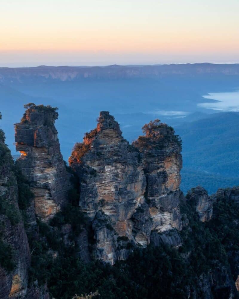 Scenic view of the Three Sisters rock formation at sunrise in Blue Mountains, Australia.