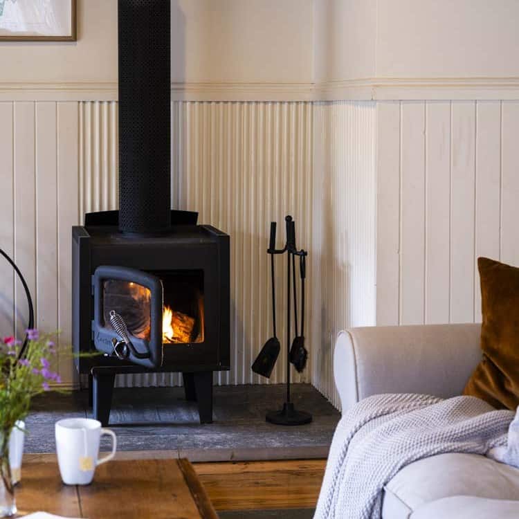 Living room with a wood-burning fireplace and comfortable seating.